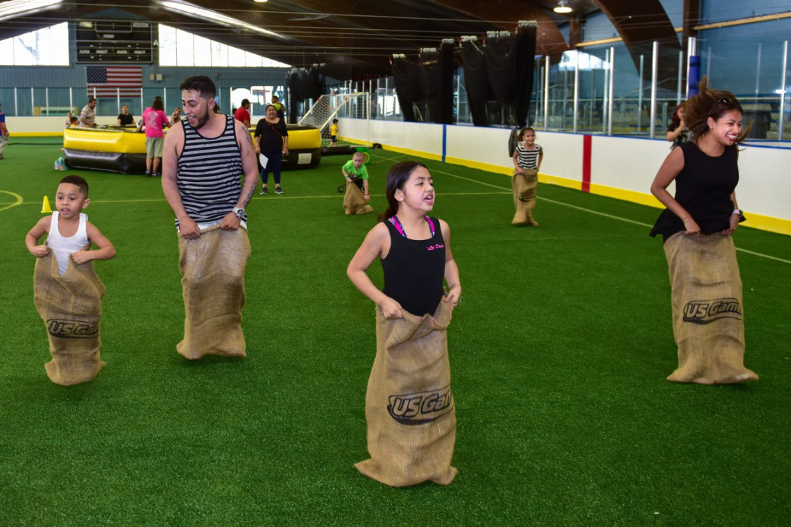 Kids engaged in a potato sack race